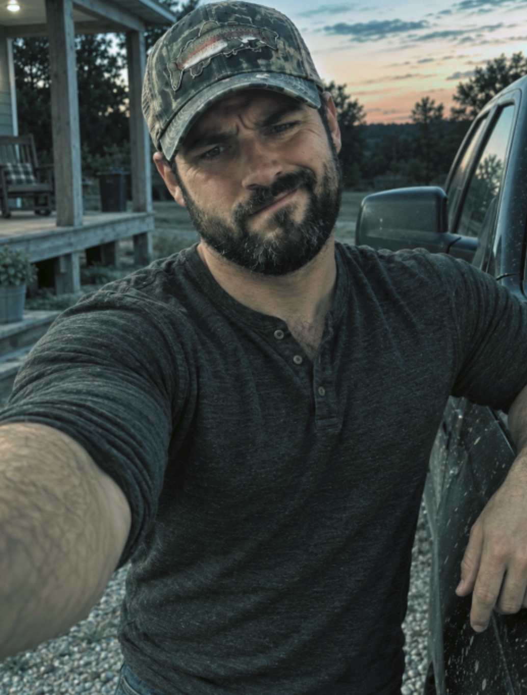 Me outside beside my truck at sunset